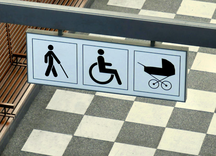 Signages for a blind person, wheelchair and baby pram above a walkway