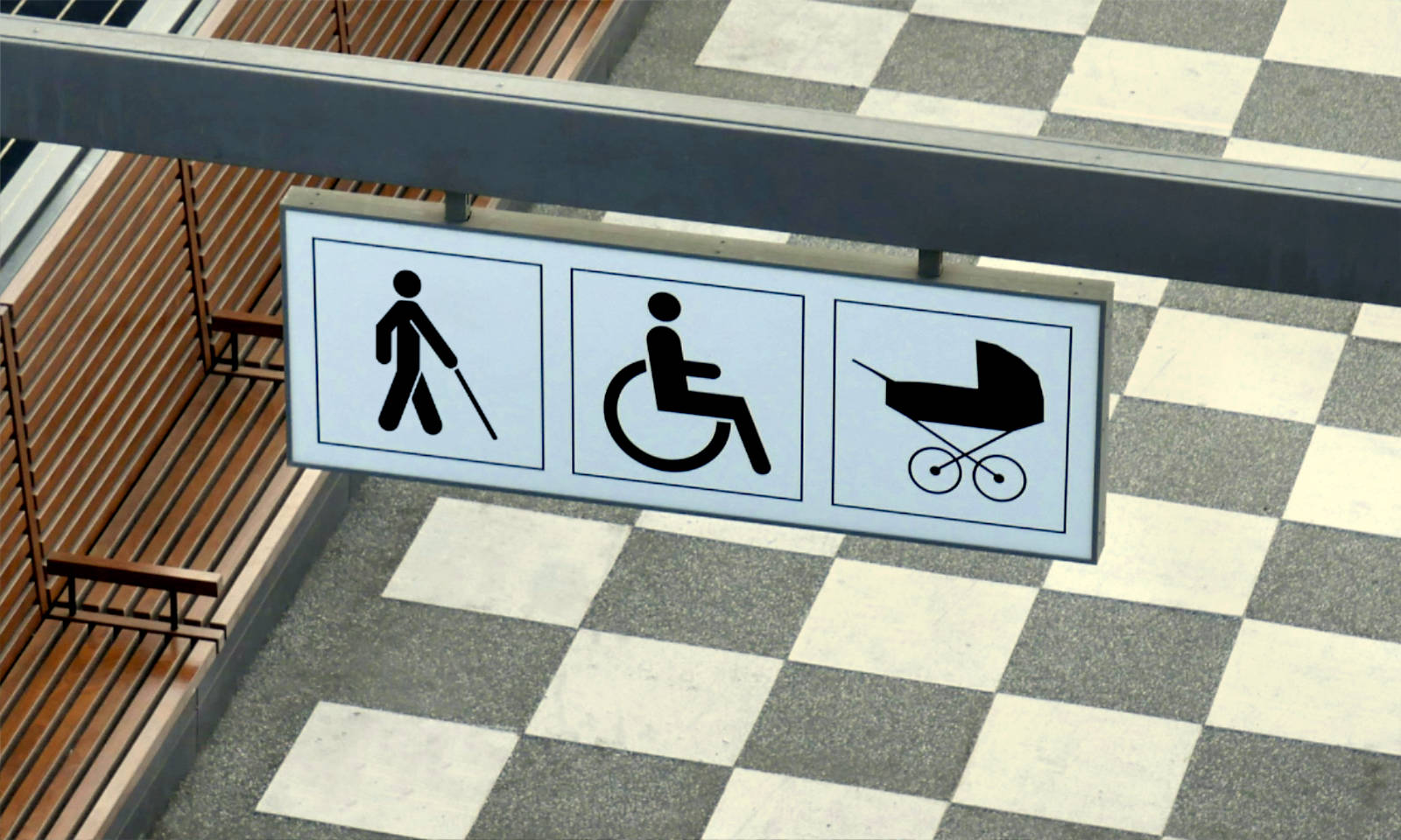 Signages for a blind person, wheelchair and baby pram above a walkway