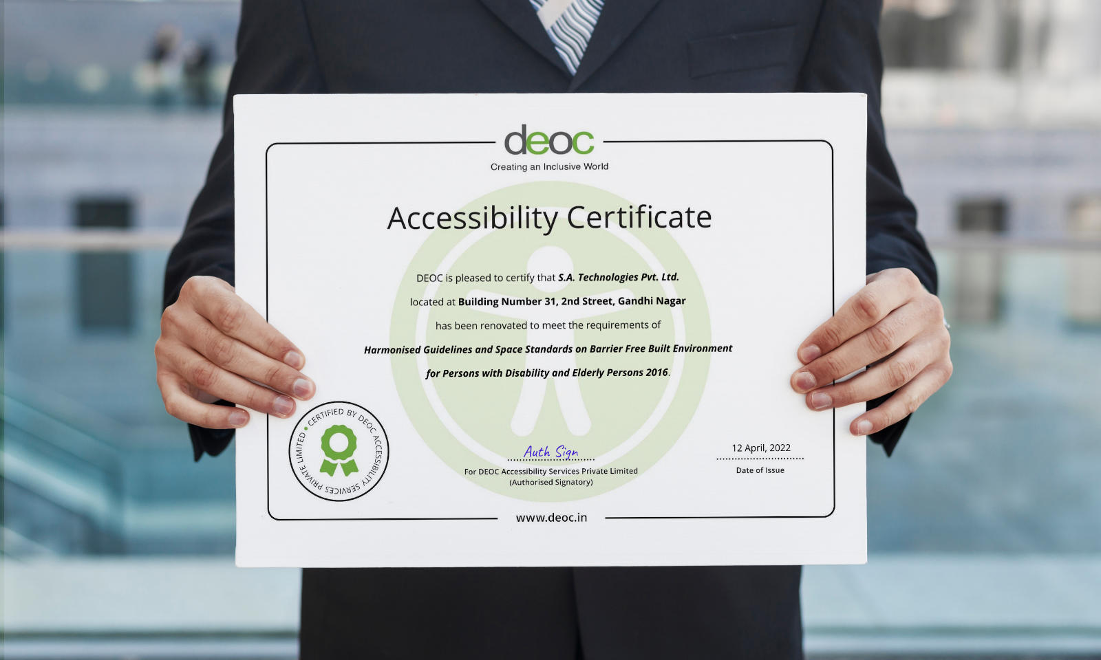 Office executive holding an Accessibility Certificate by DEOC