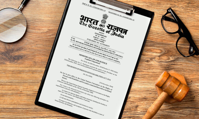 Physical copy of a legal document on a desk, along with a gavel, a magnifying glass and reading glasses