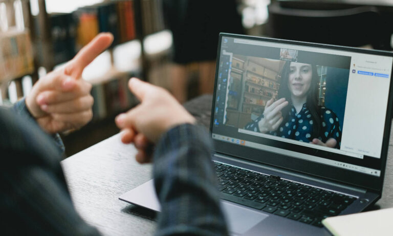 A person using sign language to communicate on a video chat